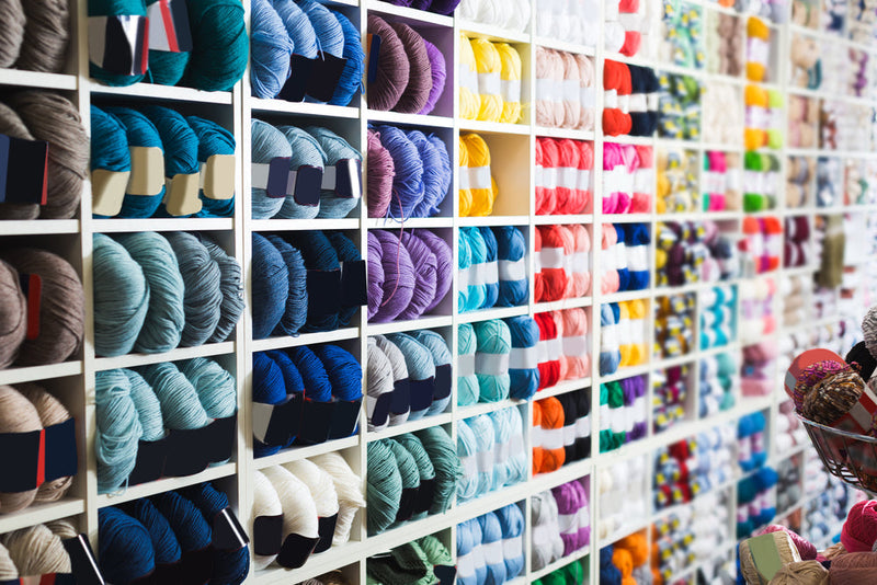 Assortment of yarns stacked in shelves