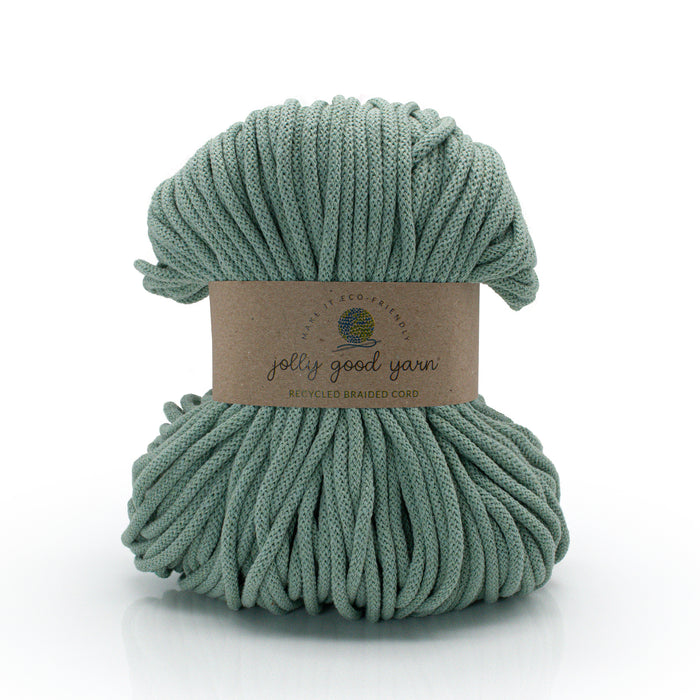 Skein of green yarn with a label on a white background