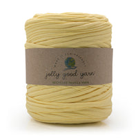 Ball of banana yellow yarn with a label on a white background