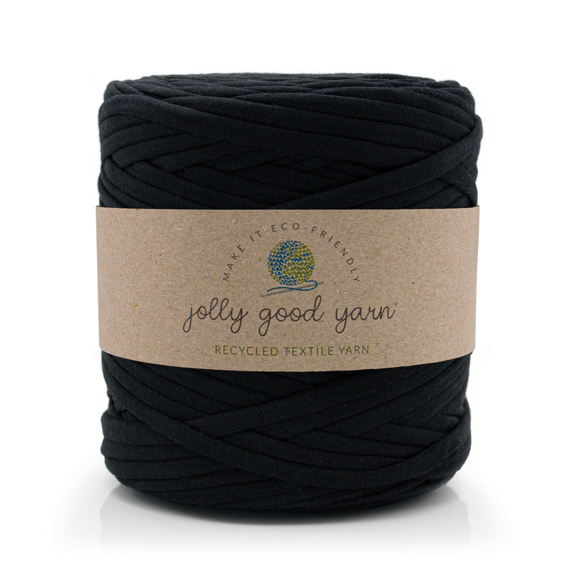 A large skein of black jolly good yarn with a brown kraft paper label, shown on a clean white background.