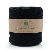 A large skein of black jolly good yarn with a brown kraft paper label, shown on a clean white background.