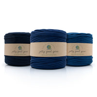 Three skeins of different shades of darker blue T-Shirt yarn with 'jolly good yarn' labels on a white background