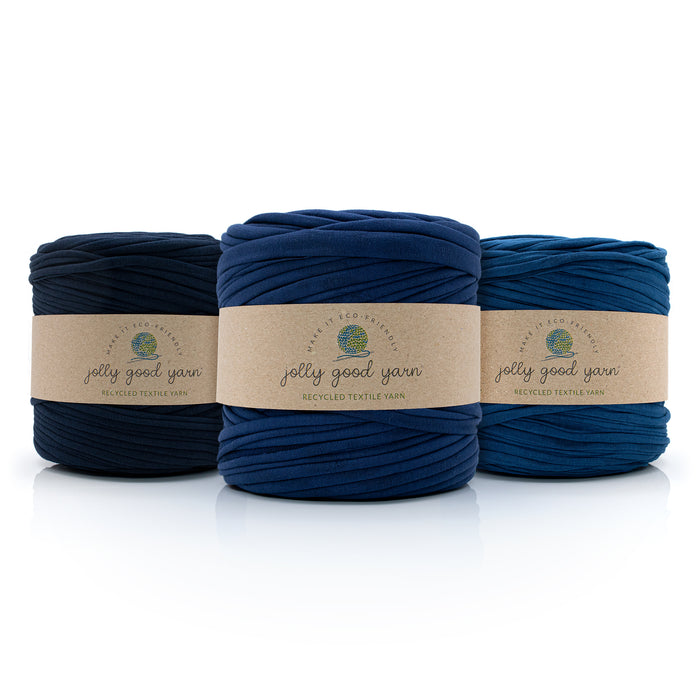 Three skeins of different shades of darker blue T-Shirt yarn with 'jolly good yarn' labels on a white background