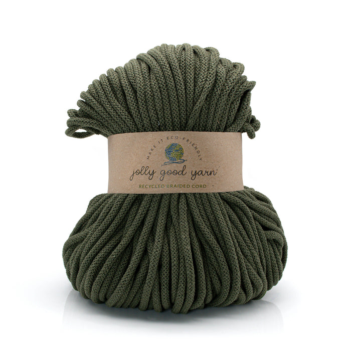 Green yarn ball with a label on a white background