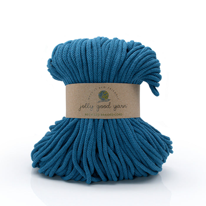 Blue yarn ball with a label on a white background