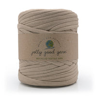 Ball of beige yarn with a 'jolly good yarn' label on a white background