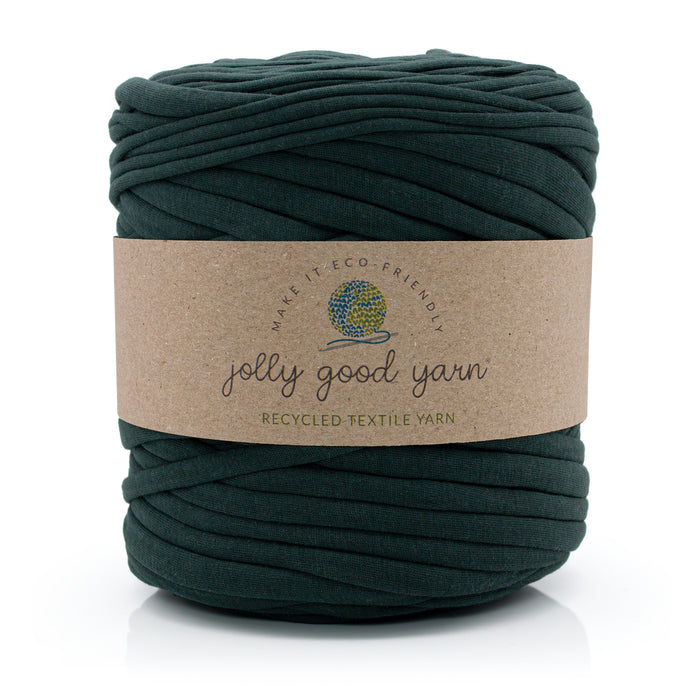 A skein of dark forest green recycled textile yarn with a brown paper label reading 'jolly good yarn' on a white background.