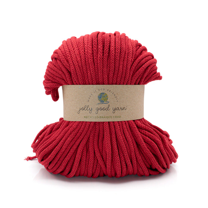 A skein of thick, chunky braided cord in a vibrant red color, wrapped with a natural kraft paper label that reads 'jelly good yarn'. The product is photographed on a clean white background with a soft shadow underneath.