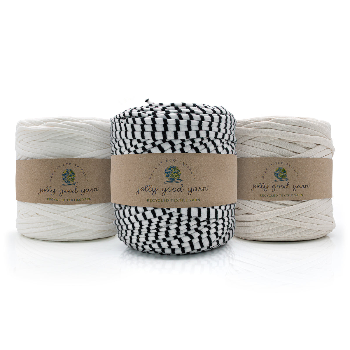 Three skeins of twisted cotton yarn from Jelly Good Yarn arranged in a row. The left and right skeins are off-white/cream, and the center skein is black and white striped.