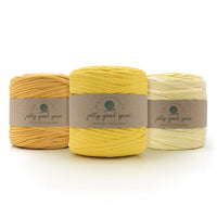 Three balls of different shades of yellow T-Shirt yarn with 'jolly good yarn' labels on a white background