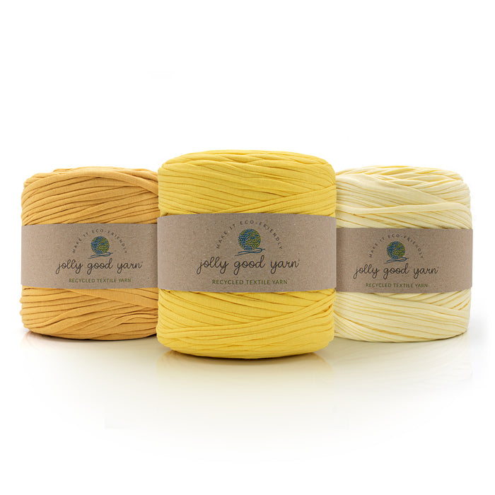 Three balls of different shades of yellow T-Shirt yarn with 'jolly good yarn' labels on a white background